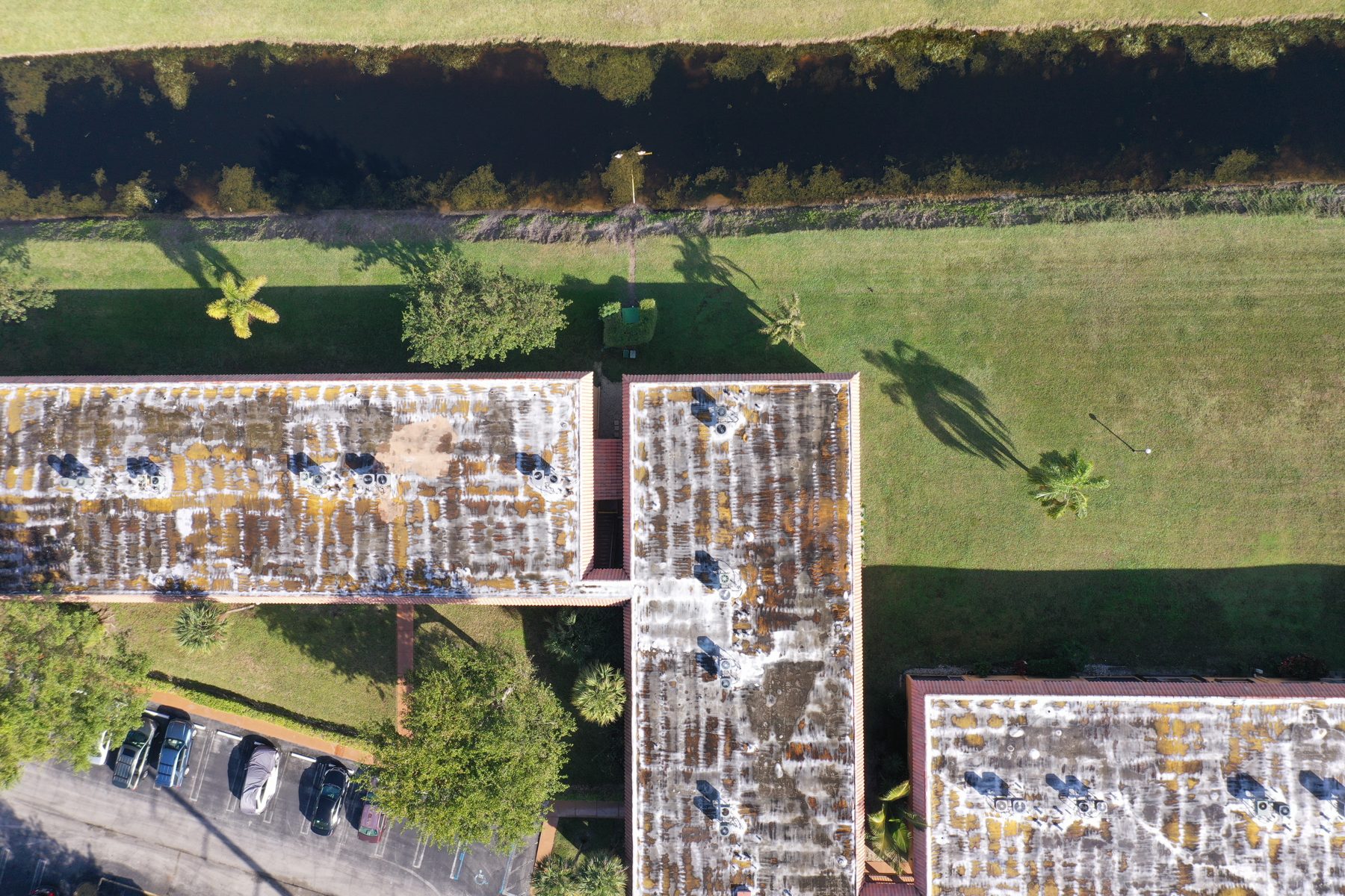 Aerial view of an L-shaped association building, lawn, and parking.